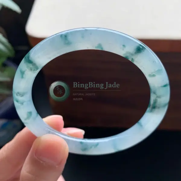 Icy Floating Emerald Bangle — Drifting Green Blooms on Blue Glass
