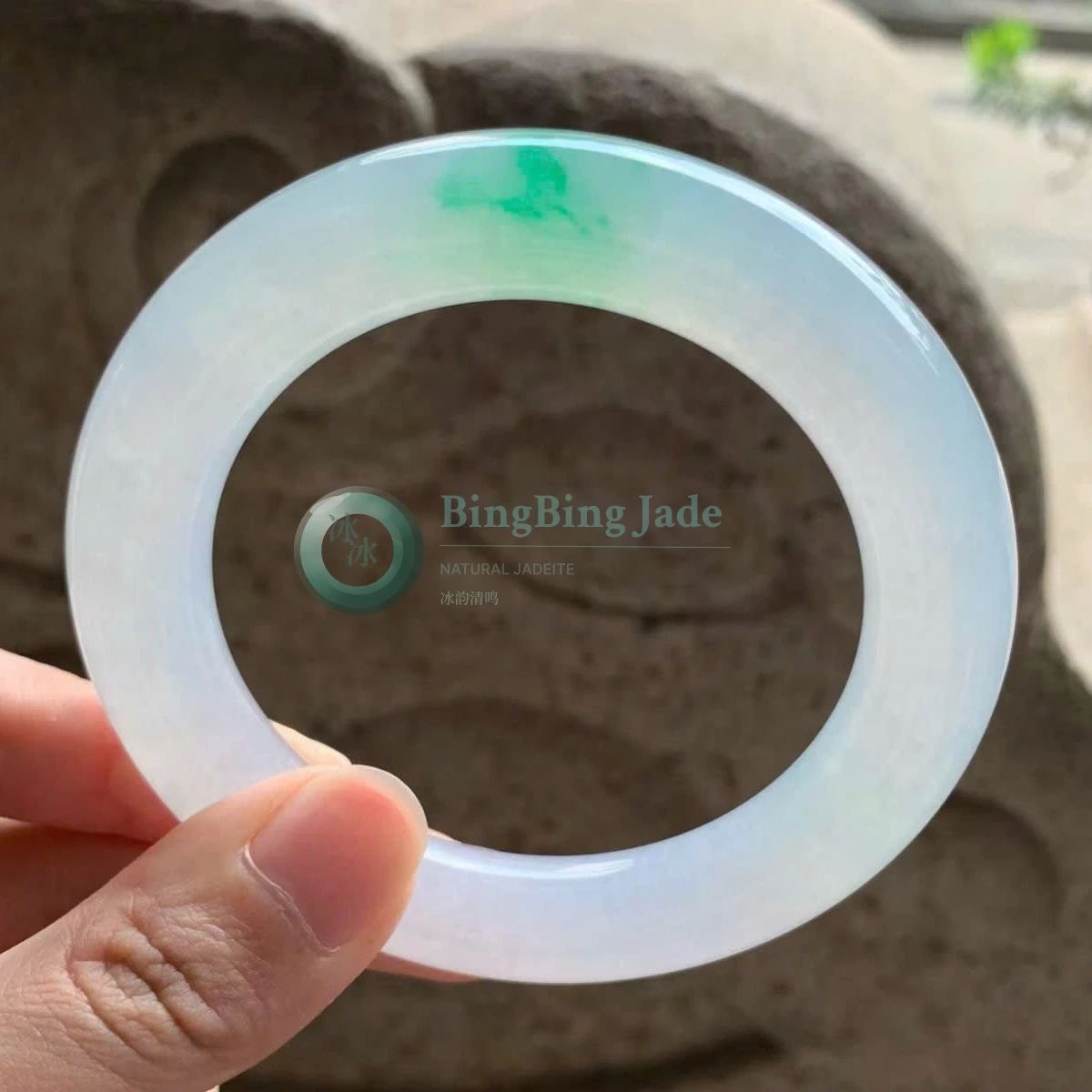 Icy White Bangle with Floating Emerald Kiss · 57mm