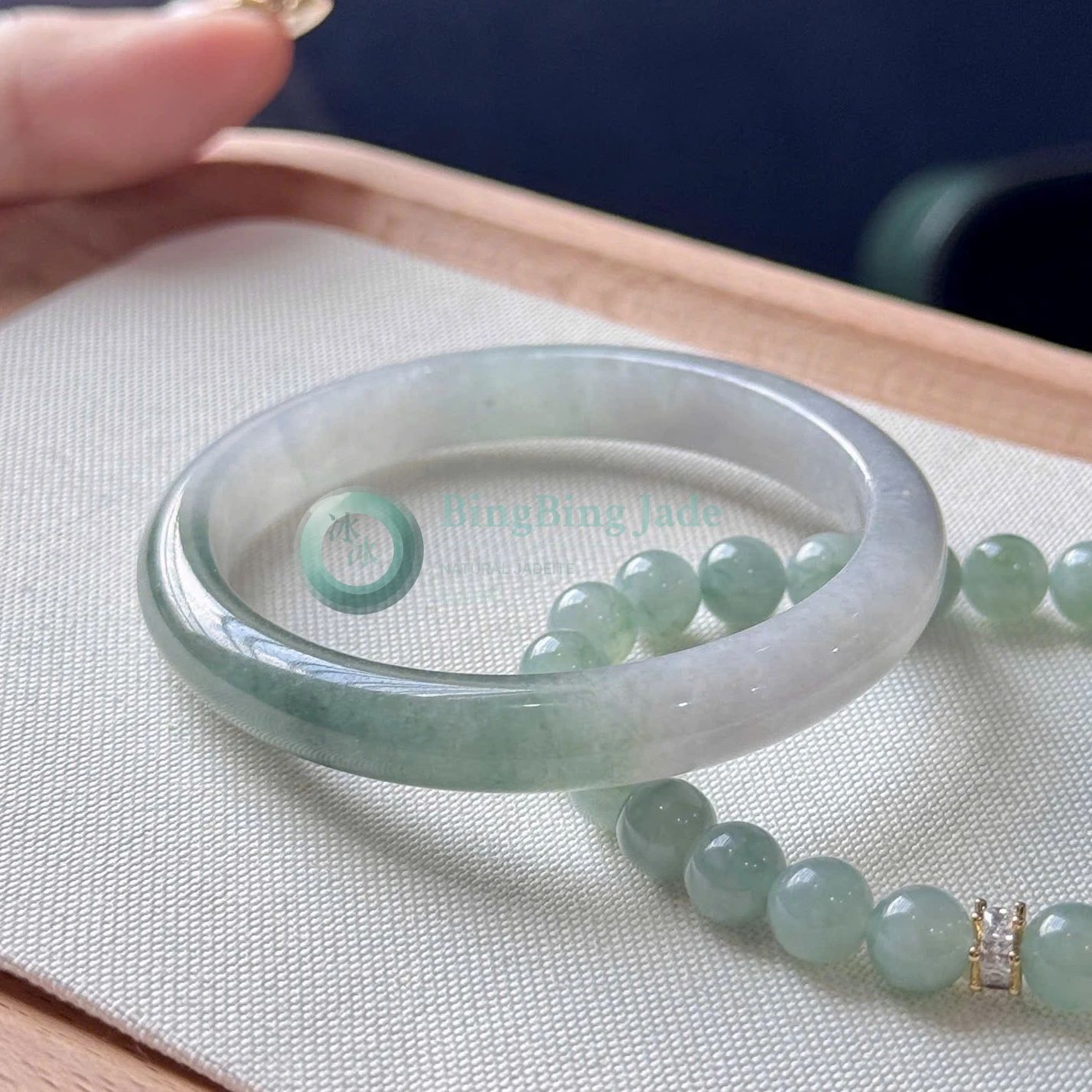 Soft Mist with Spring Green Bloom — Oval Jadeite Bangle 55.5mm