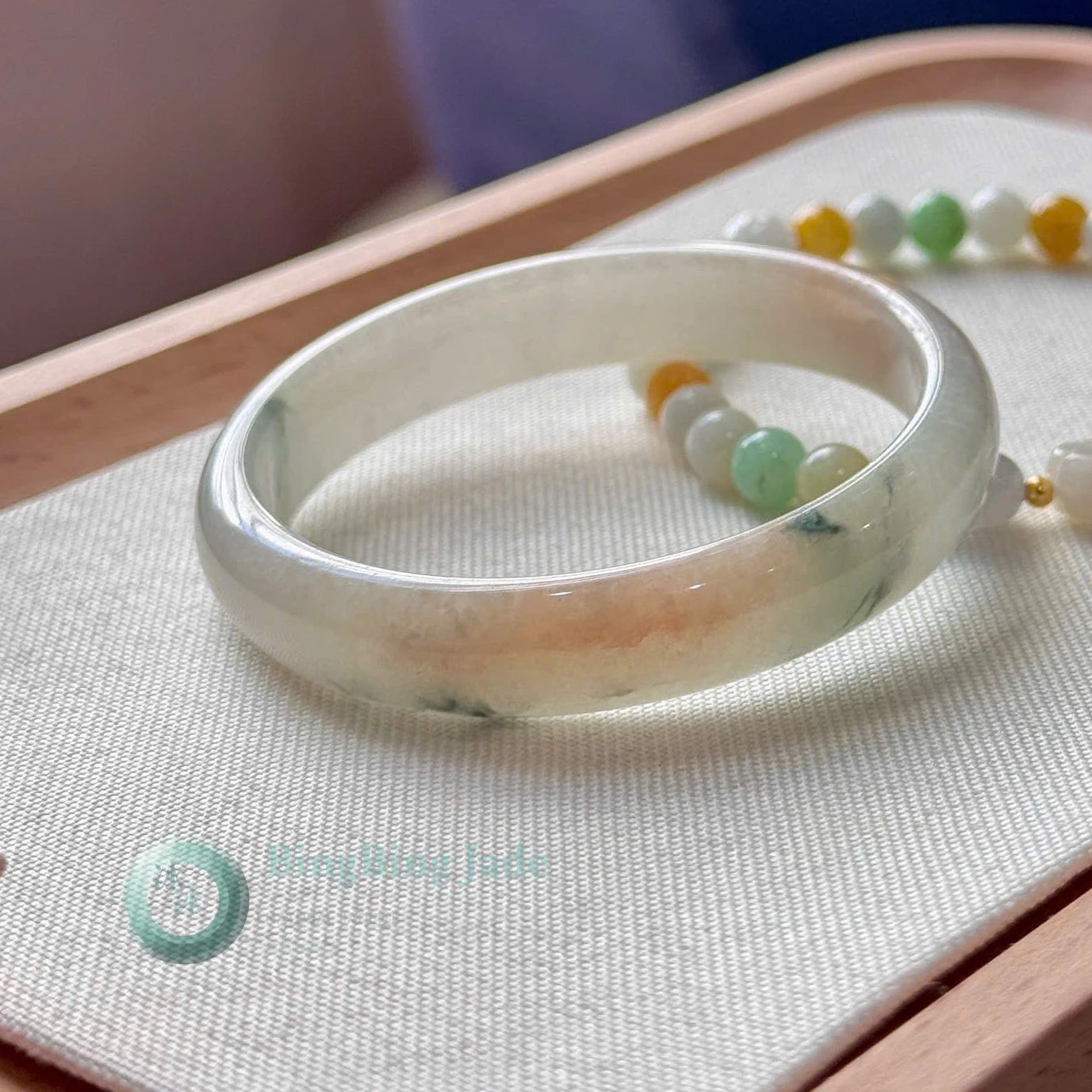 Sunlit Koi — Warm Apricot Bloom on Translucent Jadeite Bangle 50mm